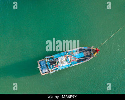 Top view. Aerial view from drone. Royalty high quality free stock footage of the fishing boat on the beach. Fishing boat is mooring on beach alone Stock Photo