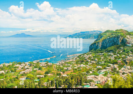 beautiful aerial view of Marina Grande port, boats and houses on island of Capri with Mount Vesuvius at background on sunny summer day Stock Photo