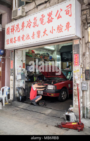 Man Fixing A Car In A Car Shop On The Streets Of Hong Kong Stock Photo Alamy