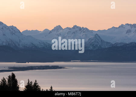 The Homer Spit is quiet in the pre dawn light with the Kenai Mountains glowing blue in the first light of morning. Stock Photo