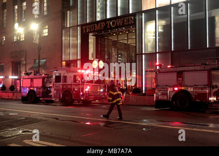 New York City - April 7, 2018:  Firefighters stationed outside Trump Tower after a fire broke out earlier this evening on the 50th floor.  One person was killed and at least four others were injured. Stock Photo