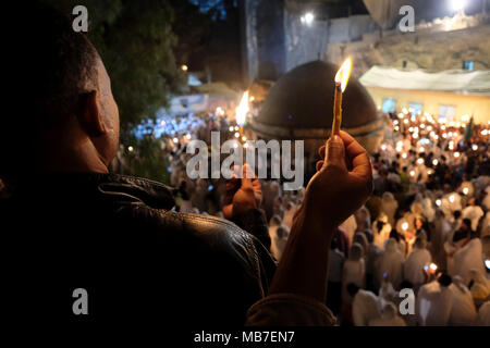 Jerusalem, Israel. 7th April 2018. Ethiopian Orthodox Christians light candles during the Holy Fire ceremony at Deir El-Sultan monastery located on roof of the Church of Holy Sepulchre in the Old City East Jerusalem Israel. Ethiopian Christians commemorate events around the crucifixion of Jesus Christ, leading up to his resurrection on Easter which in the Amharic language, is referred to as Fasika, originated from the Greek word Pascha. Stock Photo