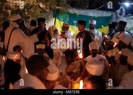 Jerusalem, Israel. 7th April 2018. Ethiopian Orthodox Christians light candles during the Holy Fire ceremony at Deir El-Sultan monastery located on roof of the Church of Holy Sepulchre in the Old City East Jerusalem Israel. Ethiopian Christians commemorate events around the crucifixion of Jesus Christ, leading up to his resurrection on Easter which in the Amharic language, is referred to as Fasika, originated from the Greek word Pascha. Stock Photo