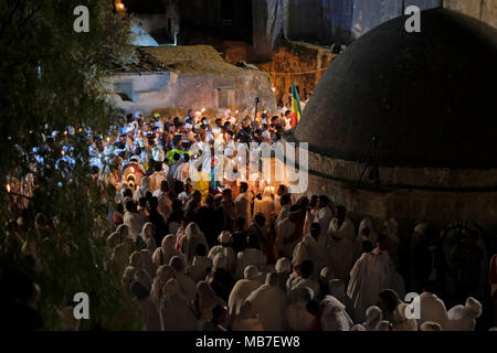 Jerusalem, Israel. 7th April 2018. Ethiopian Orthodox Christians light candles during the Holy Fire ceremony at Deir El-Sultan monastery located on roof of the Church of Holy Sepulchre in the Old City East Jerusalem Israel. Ethiopian Christians commemorate events around the crucifixion of Jesus Christ, leading up to his resurrection on Easter which in the Amharic language, is referred to as Fasika, originated from the Greek word Pascha. Stock Photo