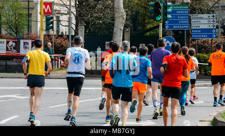 Milan, Italy - April 8th, 2018: Enthusiastic participants at the 18th Annual Milan Marathon, where some 20,000 runners have participated. Millions of euros has been raised for multiple charities supporting various causes Stock Photo