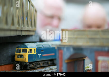 Model railway enthusiasts enjoying their model railway layouts Stock Photo