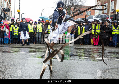 Southall, UK. 8th April, 2018. A Sikh martial arts display during the Vaisakhi Nagar Kirtan procession from the Havelock Road Gurdwara to the Park Avenue Gurdwara. Vaisakhi, which will be celebrated on 14th April, is the holiest day in the Sikh calendar, a harvest festival marking the creation of the community of initiated Sikhs known as the Khalsa. Credit: Mark Kerrison/Alamy Live News Stock Photo