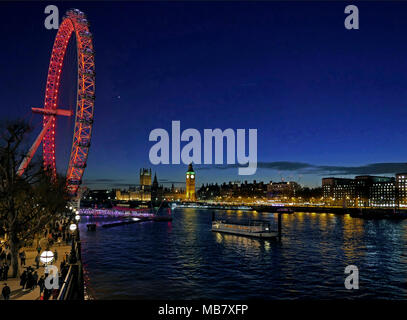 Night view of Thames from Bridge looking along South Bank, past London Eye and across River to illuminated Big Ben &Houses of Parliament. Stock Photo