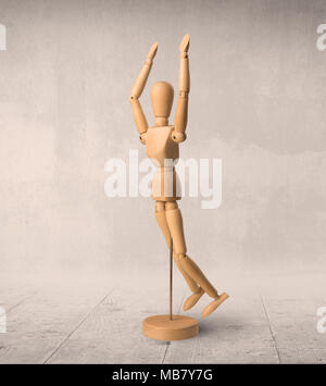 Wooden mannequin posed in front of a greyish background Stock Photo