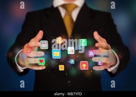 Elegant businessman holding colorful mixed media icons  Stock Photo