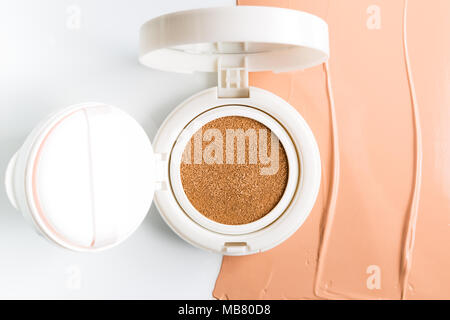 Foundation cushion with sponge and puff on white background. Stock Photo