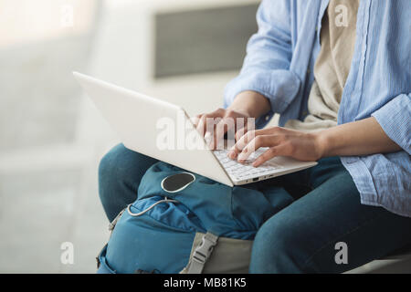 Asian man backpacking using laptop Stock Photo