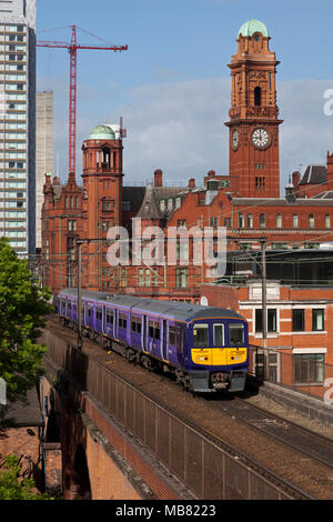 A Northern Rail class 319 electric train on the congested railway between Manchester Oxford Road an Piccadilly on Castlefield viaduct Stock Photo