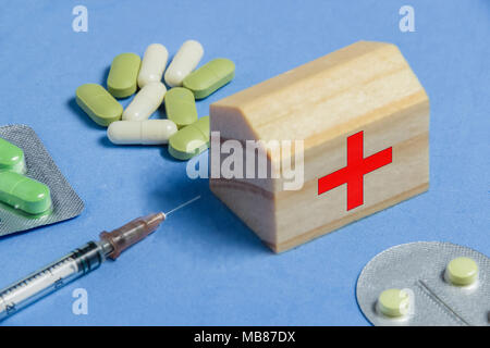 Assortment of Pills, Tablets and Capsules, Syringe on Blue Table. Medicine Ambulance Creative Concept. Stock Photo