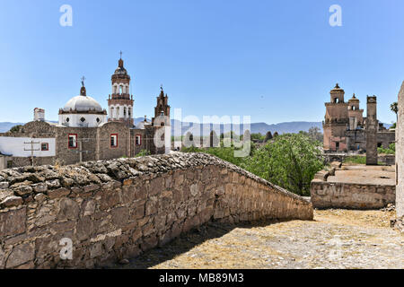 View of the Iglesia de San Diego De Alcalá church, left, and the front towers of the Hacienda de Jaral de Berrio from the old Mescal distillery in Jaral de Berrios, Guanajuato, Mexico. The abandoned Jaral de Berrio hacienda was once the largest in Mexico and housed over 6,000 people on the property. Stock Photo