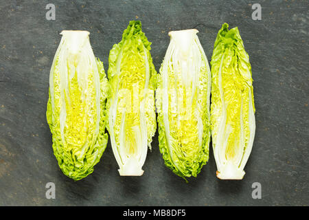 Fresh organic gem lettuces on a slate background Stock Photo