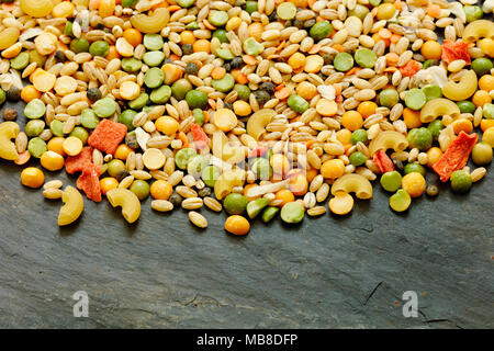 Mixed dried vegetables and pasta for vegan stew or soup with copy space Stock Photo