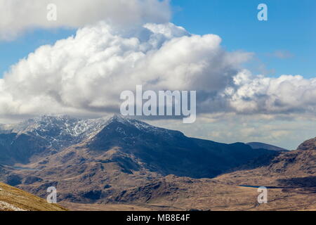 Clouds cover the snow capped summit of Snowdon. Viewed from Moel Siabod Stock Photo