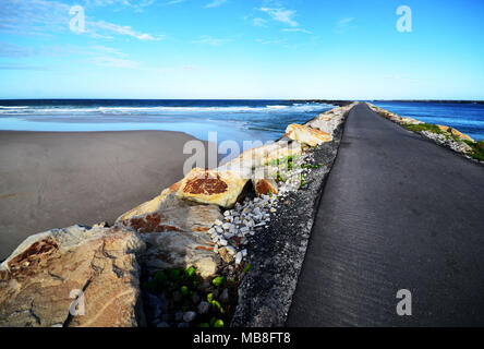 Road to nowhere extending out into the ocean Stock Photo