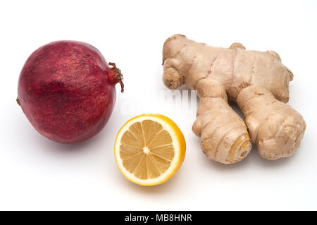 Lemon, ginger and red pomegranate on white background, isolated. Stock Photo