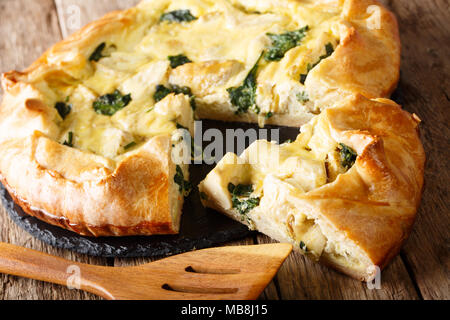 tasty pie with artichokes and spinach close-up on the table. horizontal Stock Photo