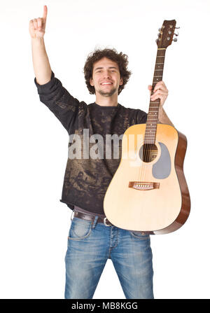 Young smiling man keeping guitare and pointing finger up Stock Photo