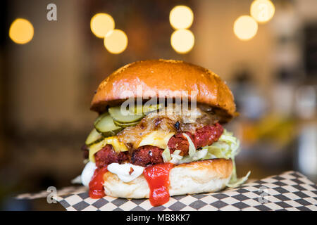 Vegan burger with vegan cheese, pickles and ketchup. Stock Photo