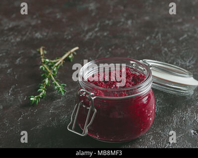 Beetroot pesto or hummus. Homemade beet pesto sauce in glass jar on dark background. Copy space for text. Ideas and recipes for healthy vegetarian detox diet and food Stock Photo