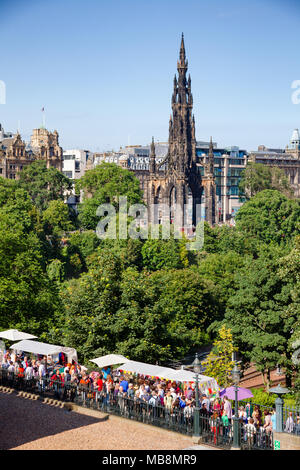 EDINBURGH, UK - AUG 8, 2012: Busy walkway to the Playfair Steps during the Fringe Festival. The Walter Scott Monument is seen in  background Stock Photo