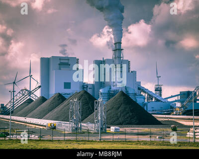 Old fashioned industrial coal powered electricity plant with pipes and smoke in black and white Stock Photo