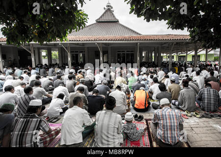 Muslims pray outside a mosque in Kensington, Brooklyn, NY 