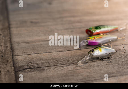 Fishing lures on a wooden background Stock Photo