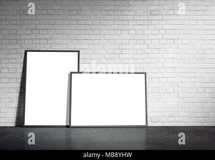 Blank paper poster in black frame at white painted brick wall and concrete floor. Grungy interior, poster mock up. Presentation for artwork. Stock Photo