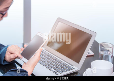 asian office woman or business woman holding smartphone and look screen of phone, office woman working by smartphone, searching data in smartphone for Stock Photo