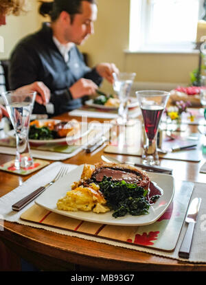 Traditional home made Beef Wellington with fillet of beef in puff pastry served with potato gratin and Cavola Nero land red wine sauce for Sunday lunc Stock Photo