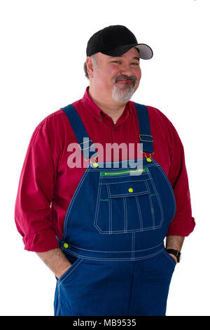 Smiling worker wearing dungarees standing against white background Stock Photo