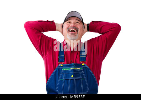 Cheerful worker wearing dungarees standing against white background Stock Photo