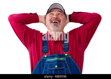 Cheerful farm worker wearing dungarees against white background Stock Photo