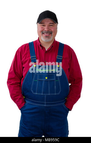 Cheerful farm worker wearing dungarees standing against white background Stock Photo