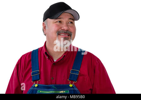 Cheerful male worker wearing dungarees standing against white background Stock Photo