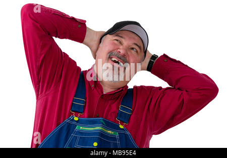 Worker, farmer or gardener in overalls with his hands behind his head looking up with his mouth open as though speaking and a thoughtful expression ov Stock Photo