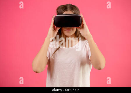 close up portrait of model in white T-shirt using vertual reality googles Stock Photo