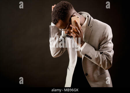 nervous black man trying ringing up to his family Stock Photo