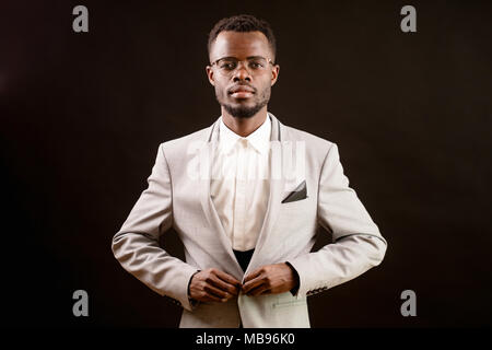 confident African man putting on fashionable Stock Photo