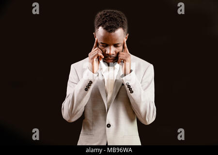 Afro stylish guy touching his temples Stock Photo