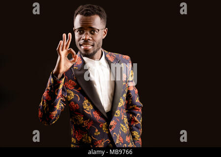 a handsome African young man showing okay gesture Stock Photo