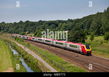 2 Virgin Trains voyager trains at Overdale, Lostock (north of Bolton)  with a train diverted from the west coast main line due to engineering work Stock Photo