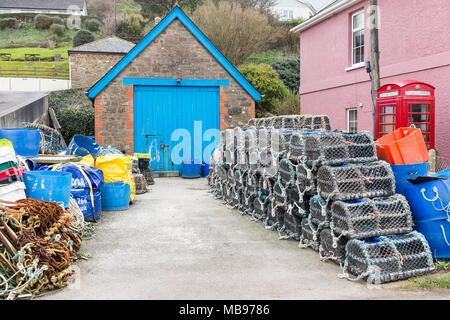 Fisherman's crab and lobster pots stacked up by a shed in the South Hams village of Hope Cove in Devon Stock Photo
