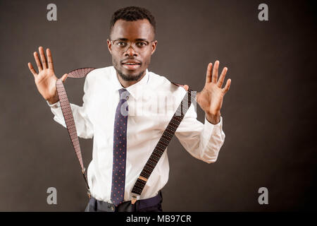 close up shot of African teacher in glasses pulling his suspenders Stock Photo