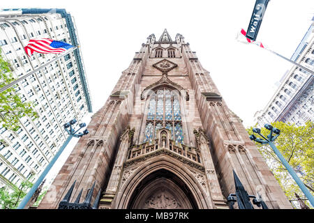 New York City, USA - October 30, 2017: Broadway St by Wall Street, isolated Trinity Church in NYC Manhattan lower financial district downtown Stock Photo